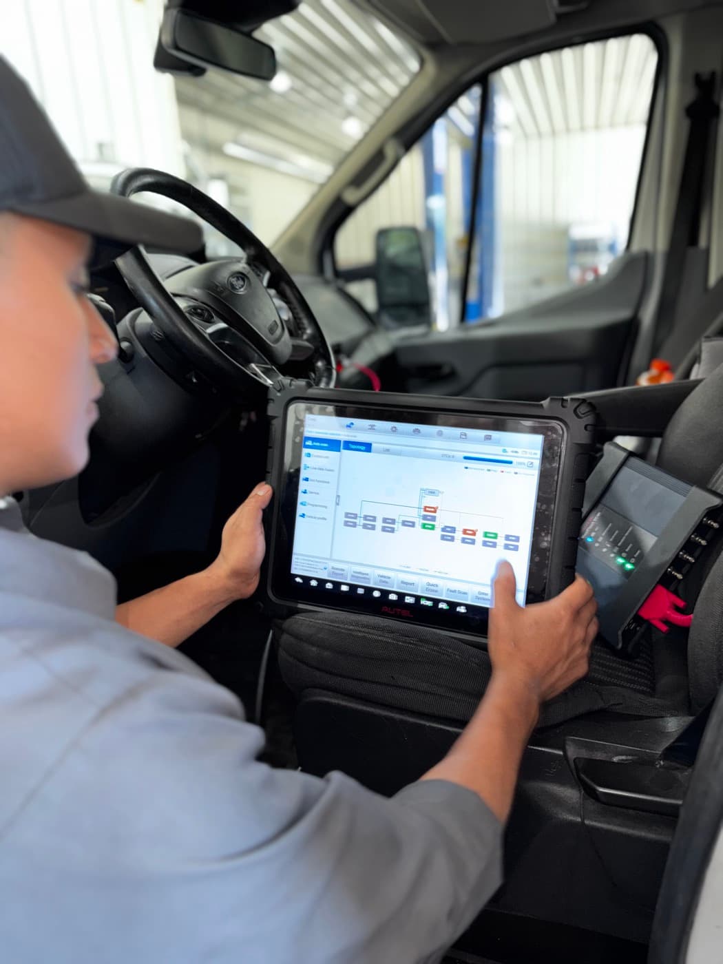 Diagnostic tablet showing a module communication topology inside a vehicle