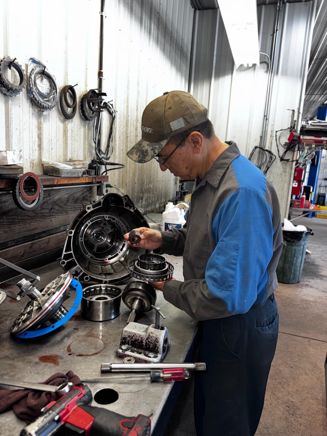 Jesse Trevino disassembling a transmission at the workbench